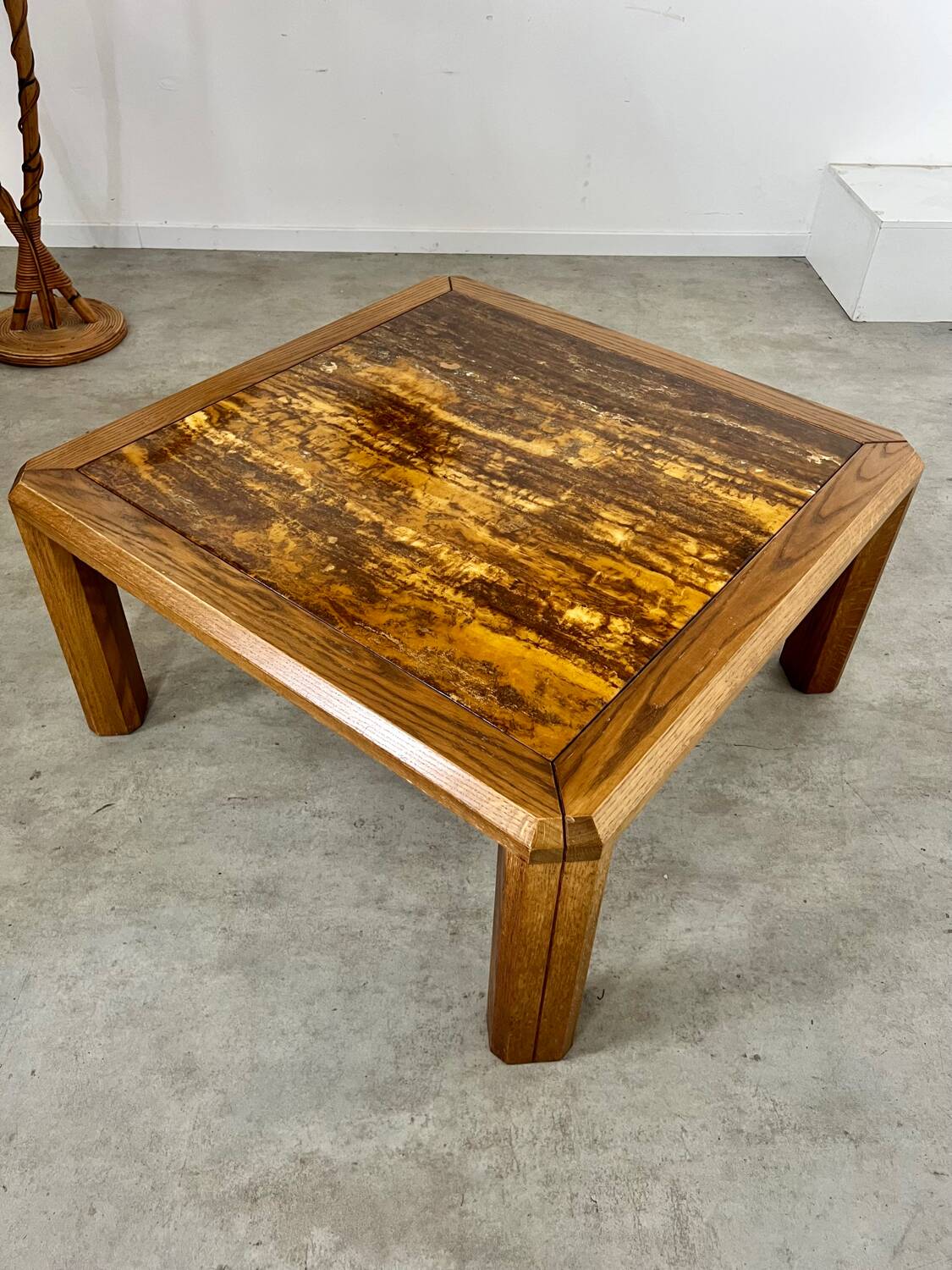 Old coffee table with golden marble top, 70s design, vintage wooden feet