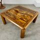 Old coffee table with golden marble top, 70s design, vintage wooden feet