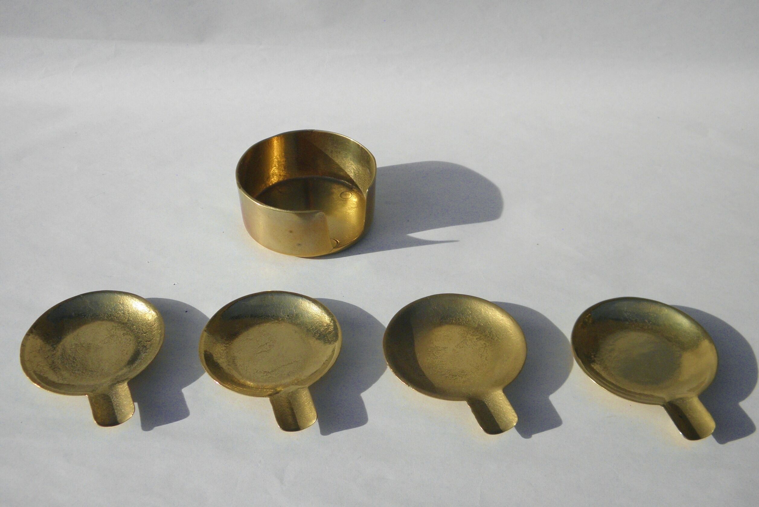 4 brass ashtrays in their 1970 case