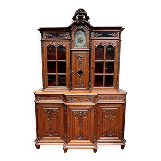 Antique rococo sideboard with integrated clock.