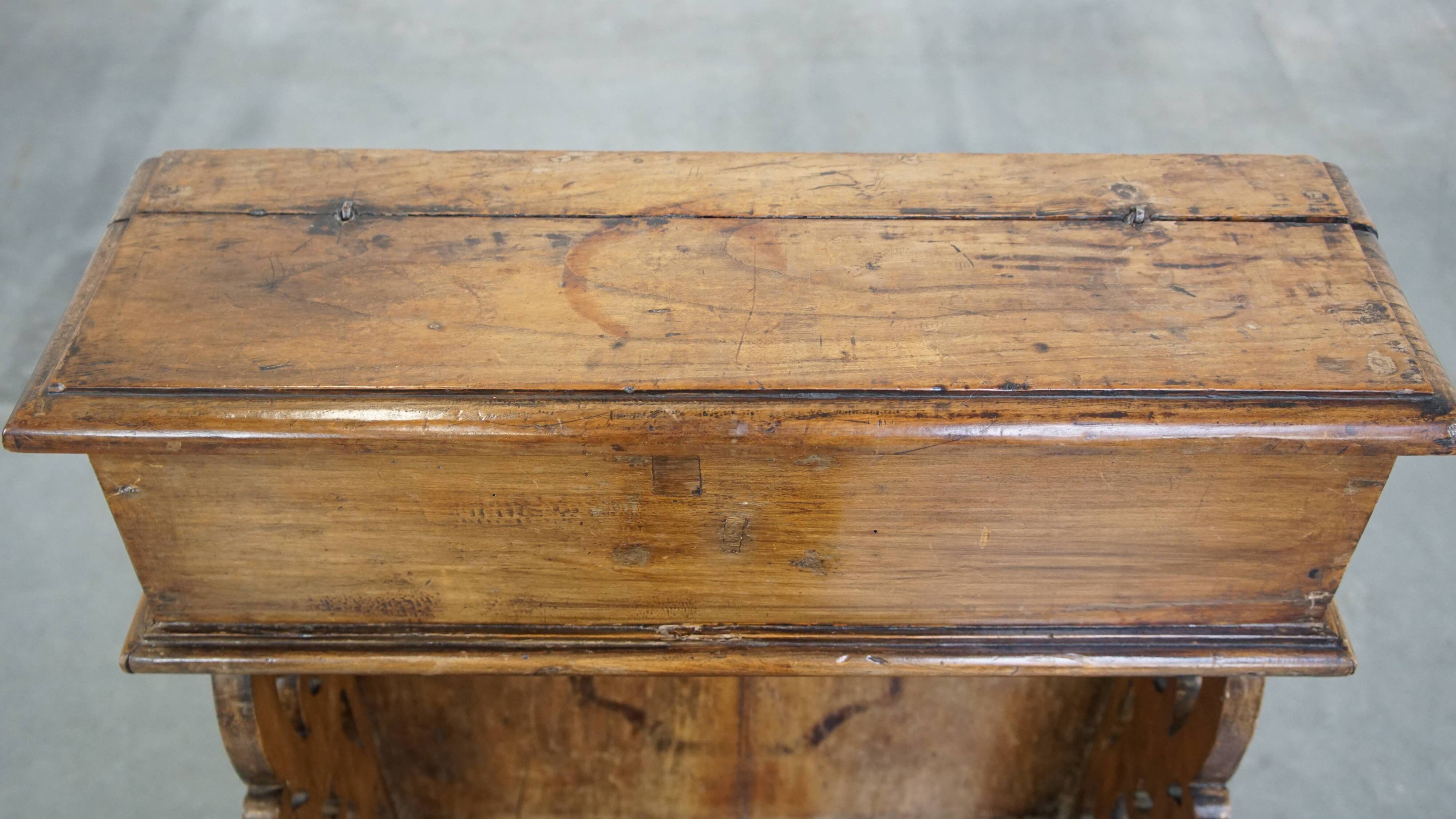 Antique pinewood church pew with storage compartments from the 18th century