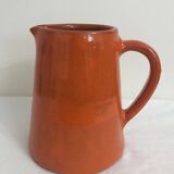 Orange glazed ceramic pitcher