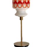 Table lamp with a vintage globe with orange patterns from the 70s and a golden base