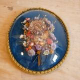Oval frame bouquet of dried flowers with curved glass
