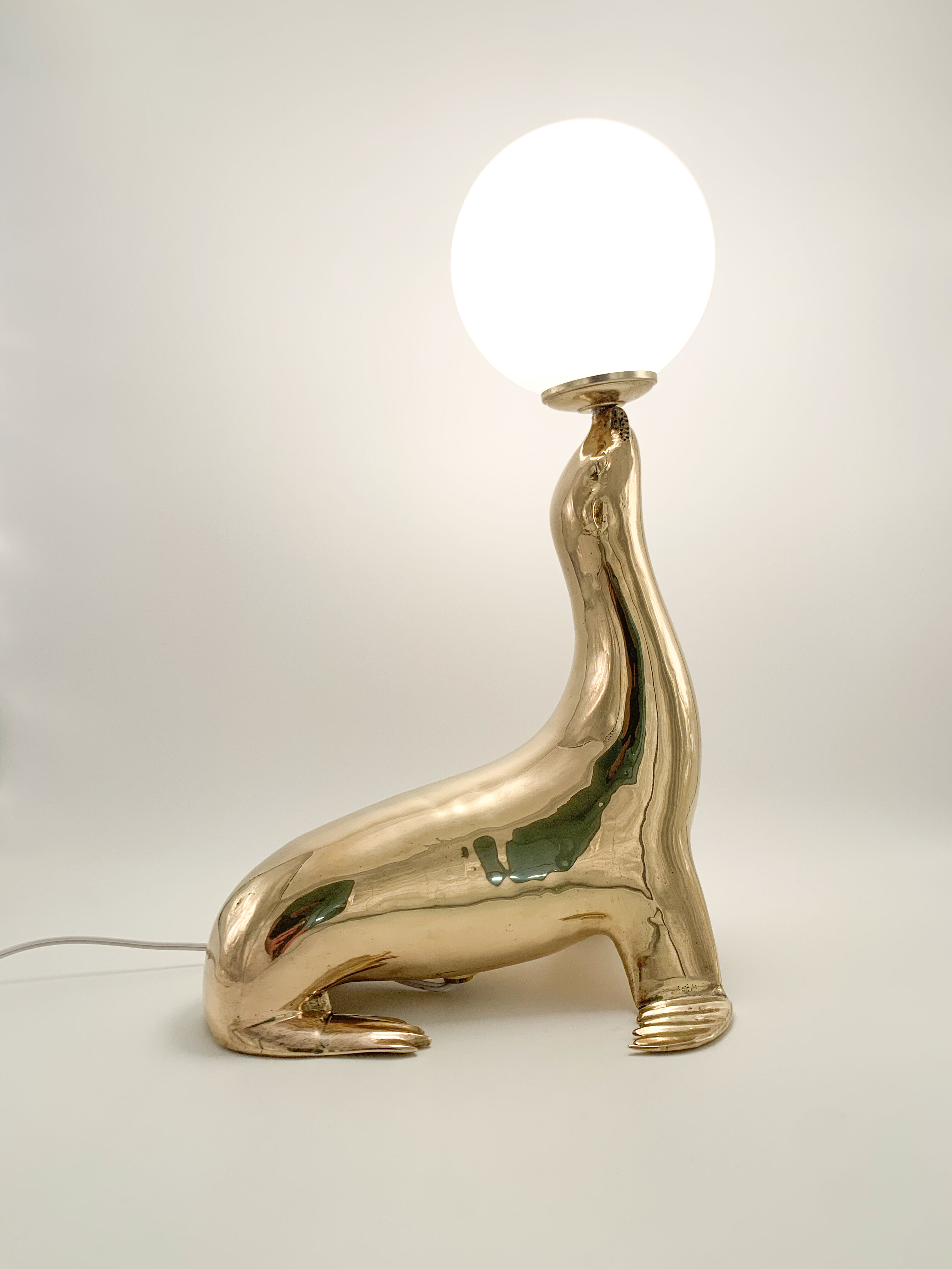 Vintage brass sea lion lamp