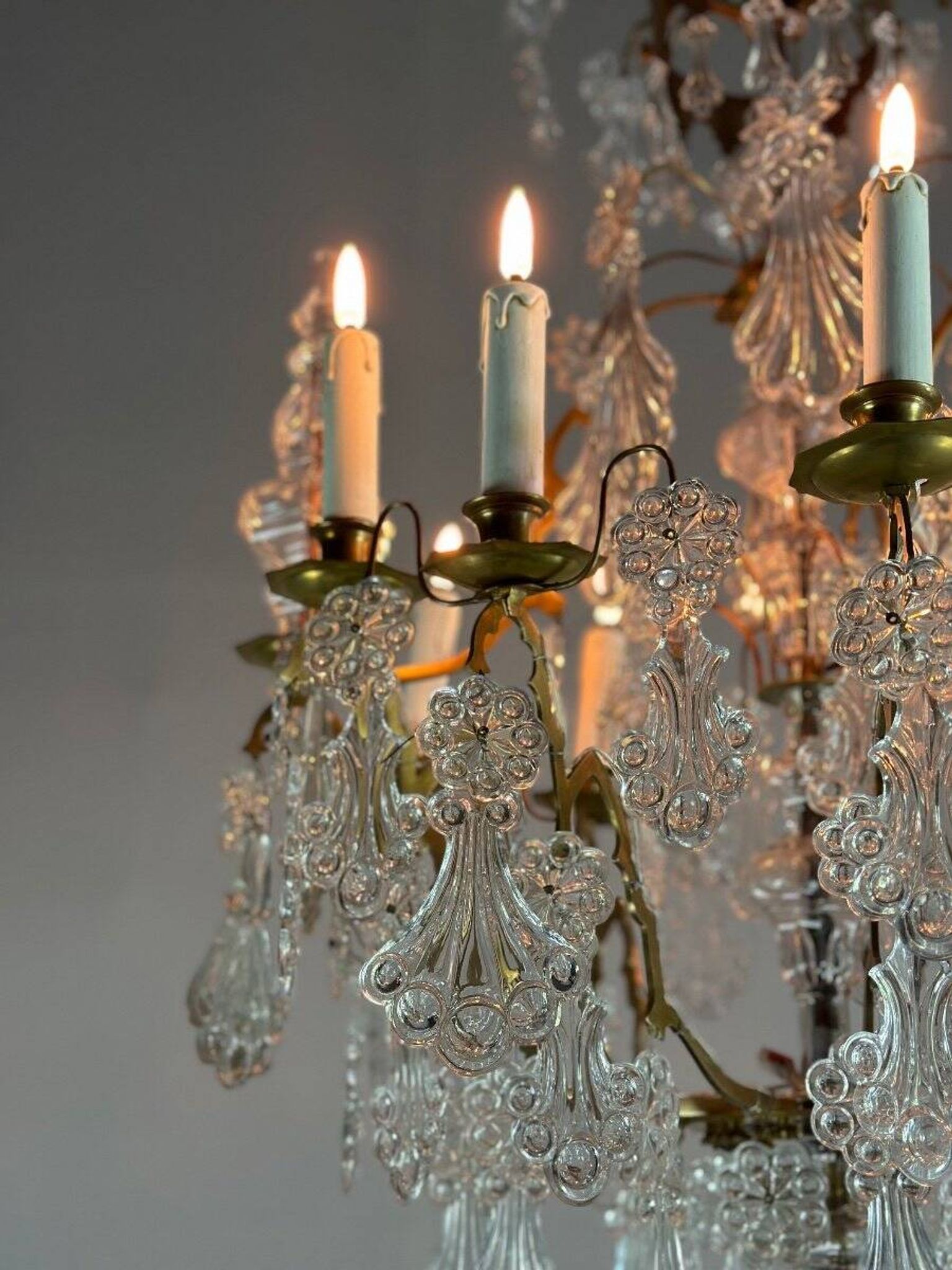 Bronze cage chandelier adorned with molded glass pendants in the shape of peacock feathers, circa 1800