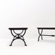 Set of 2 solid wood benches with an openwork design and wrought iron legs.