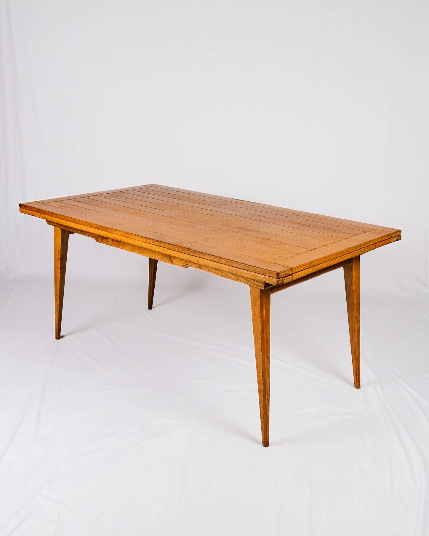 Extendable oak table in the style of Guillerme and Chambron, France 1960s