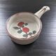 Frying pan with red fruit decoration