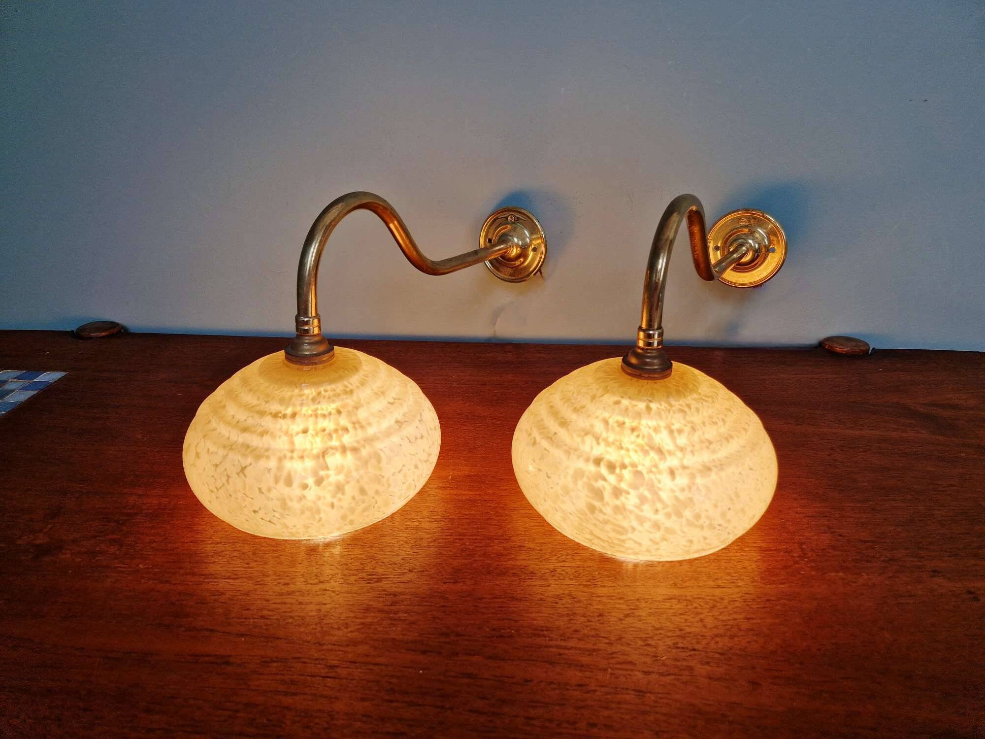 Pair of brass and yellow/white speckled glass wall sconces
