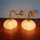 Pair of brass and yellow/white speckled glass wall sconces