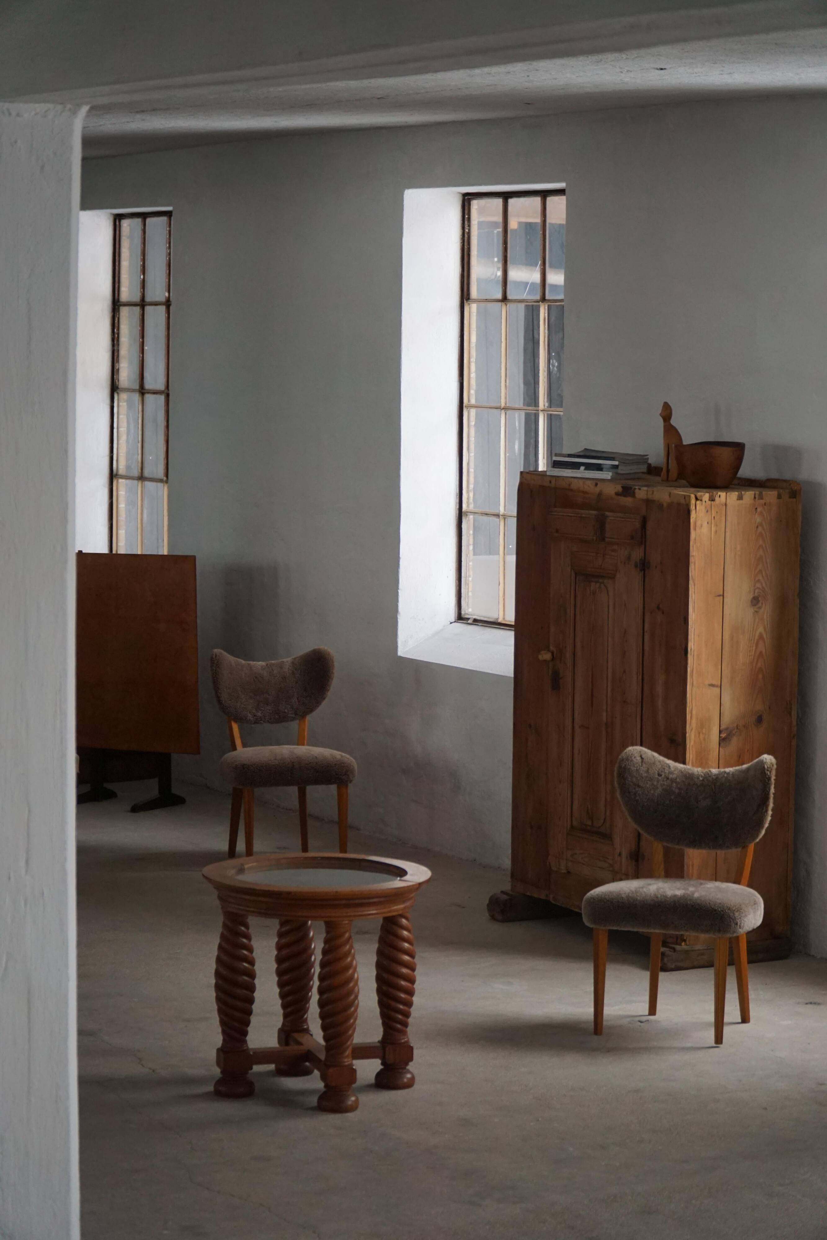 Modern Danish mid-century table, made of oak with spiral turned legs and a glass top, 1950s.