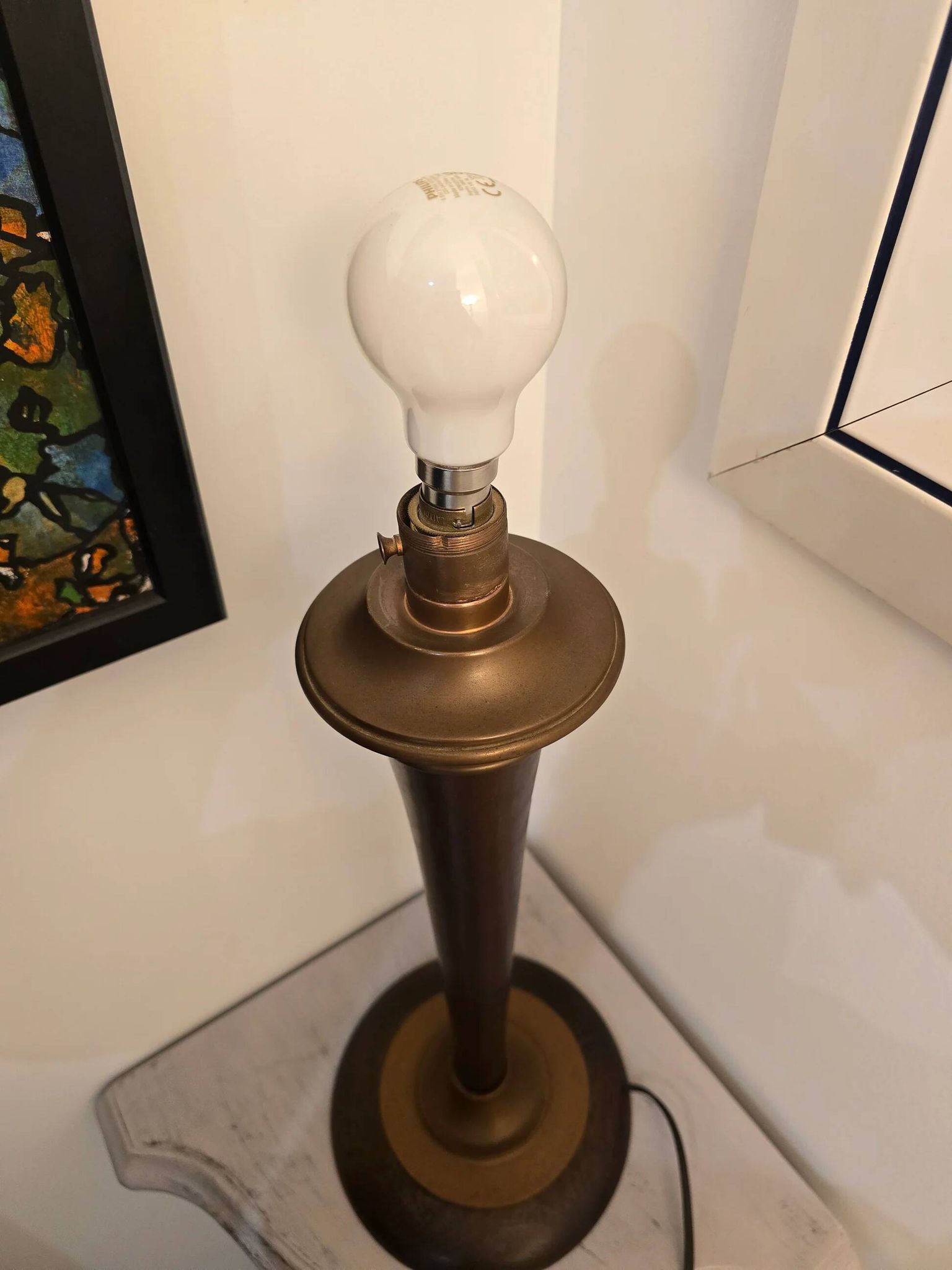 Vintage lamp base in Scandinavian style made of dark wood and bronze metal.