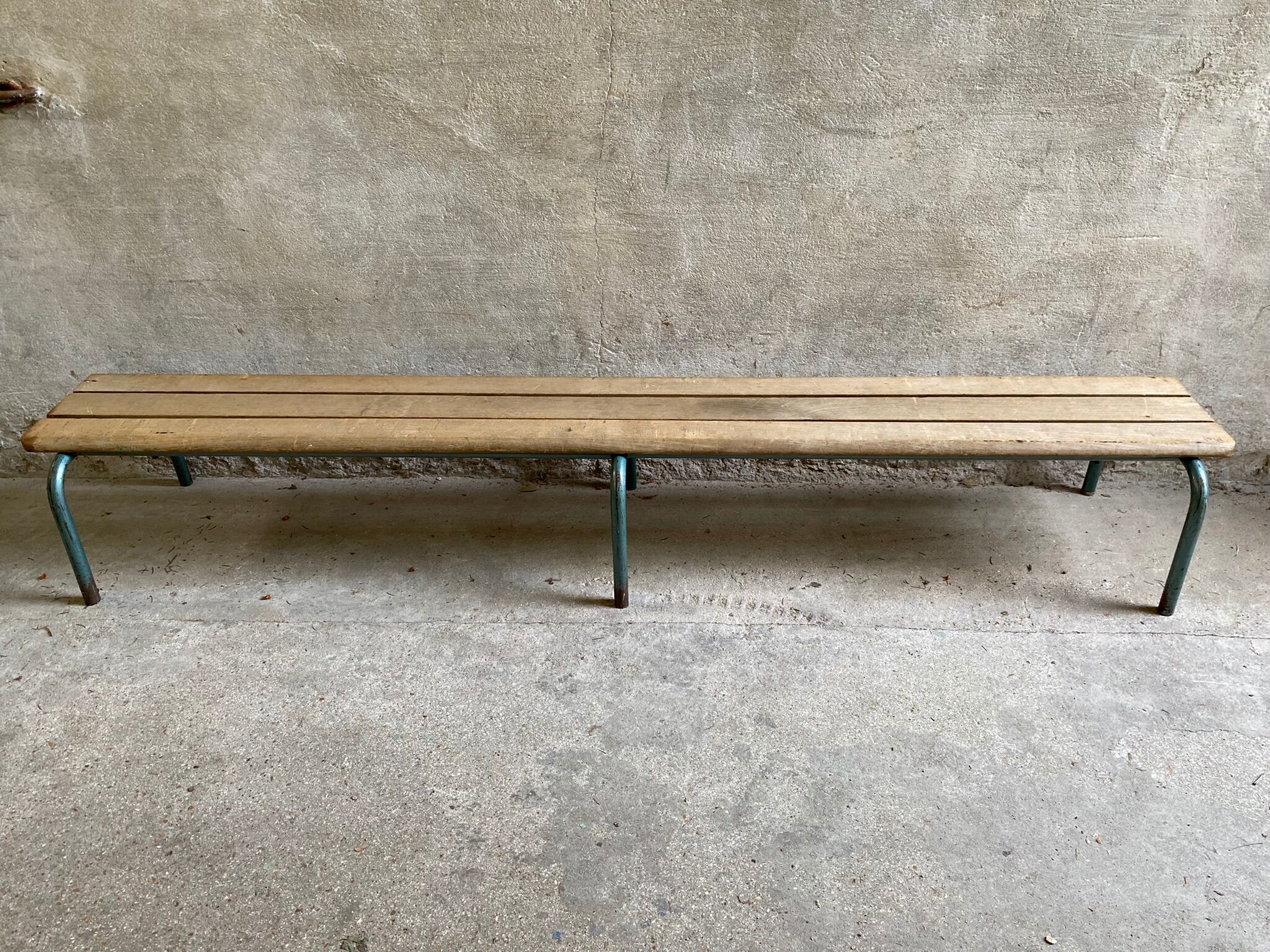 Vintage wood kindergarten bench and tubular structure in long