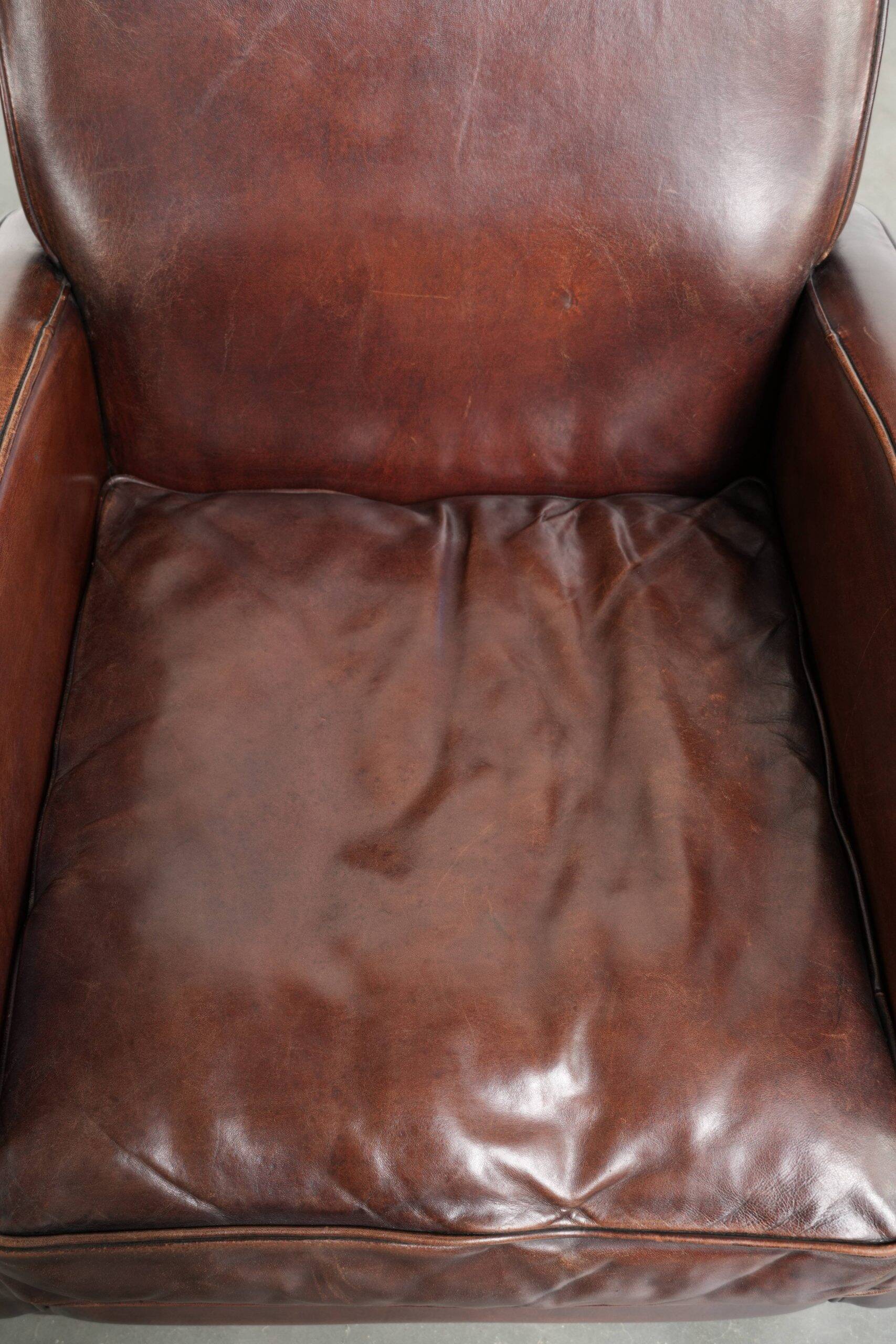 Dark cognac-coloured set of 2 sheepskin armchairs with a sleek design