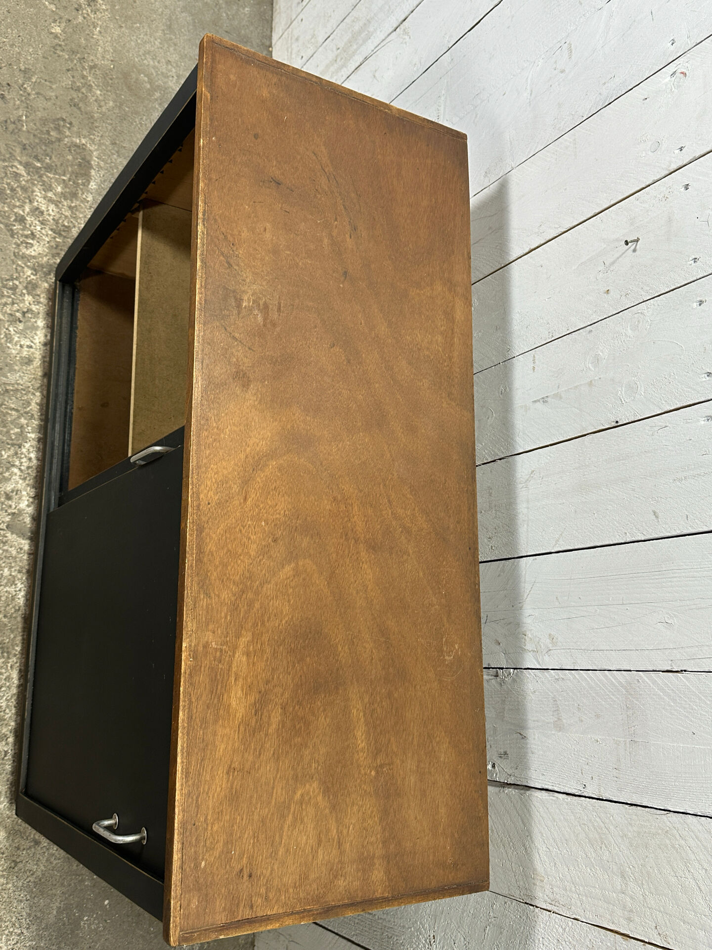 Small vintage black buffet with sliding doors.