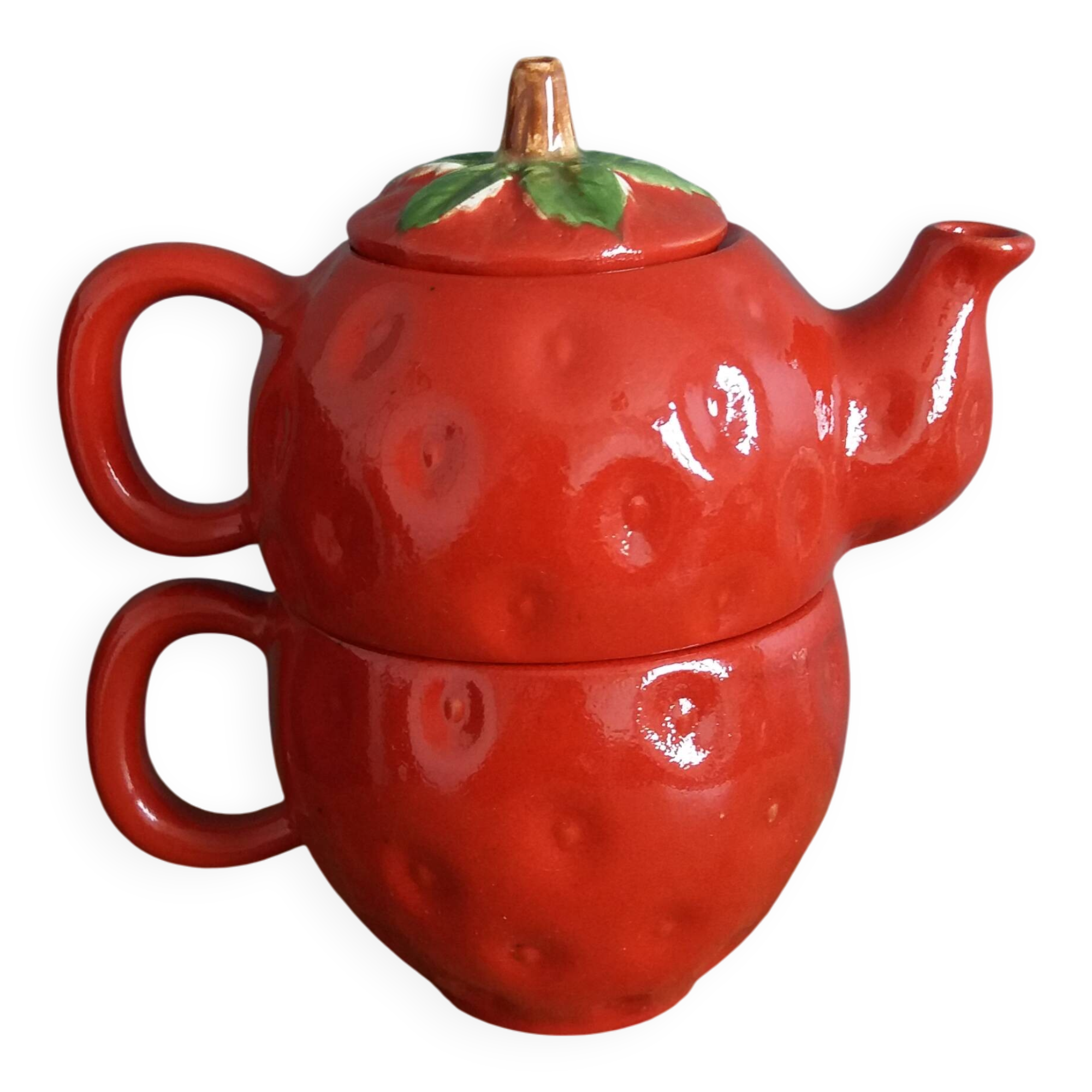 Teapot and cup in the shape of a strawberry.