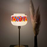 Table lamp with a vintage “flower power” glass globe and a gold base