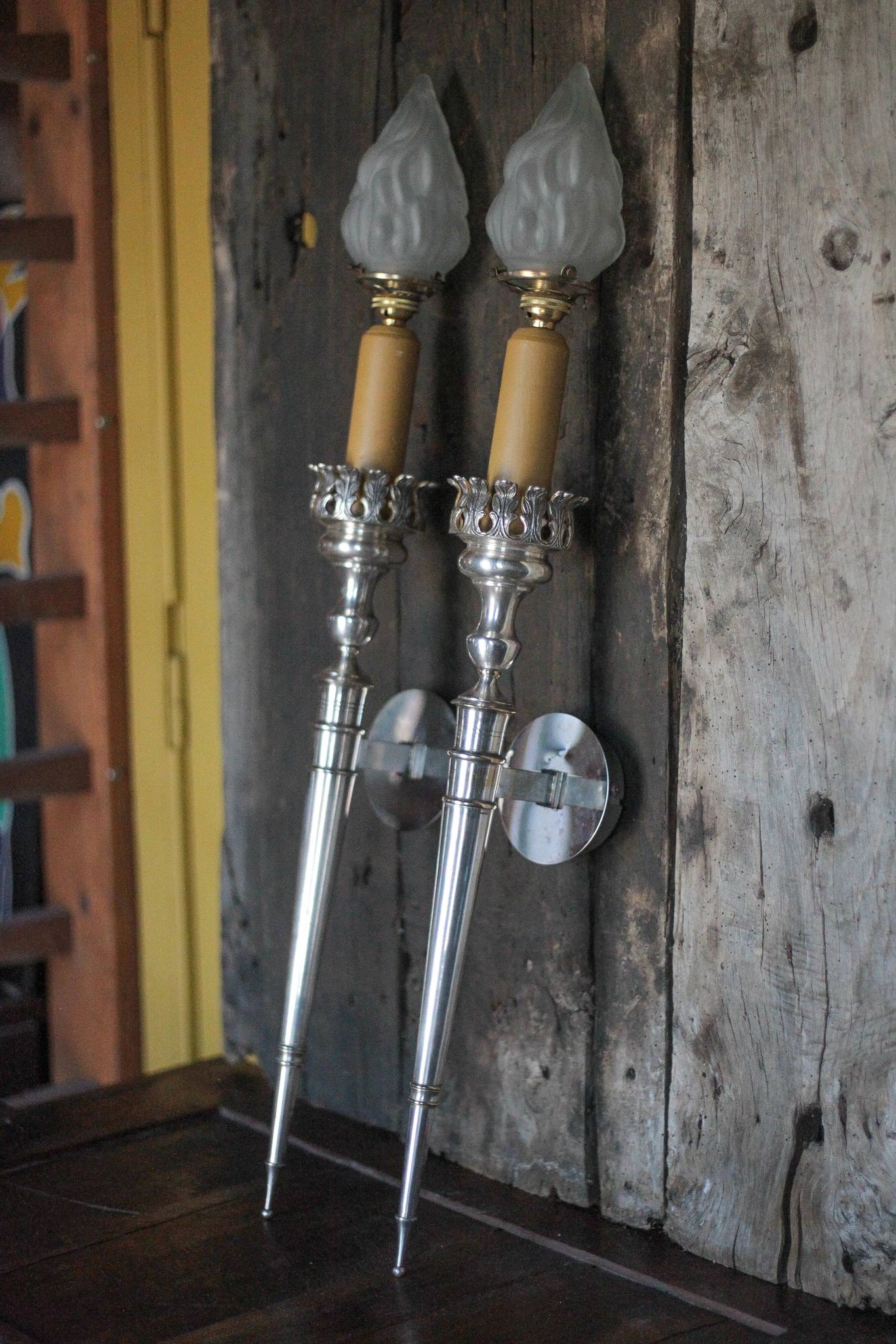 Large pair of silver-plated wall lights with flame globes, torches.