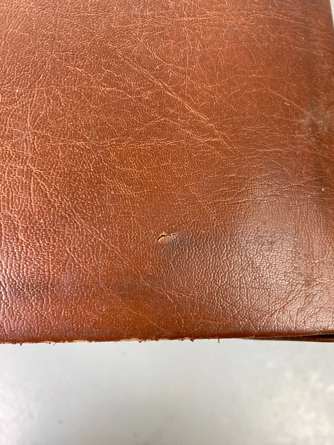 Small stool or footrest in wood and leather