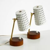 A pair of mid-century modern bedside lamps with perforated metal shades