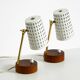 A pair of mid-century modern bedside lamps with perforated metal shades