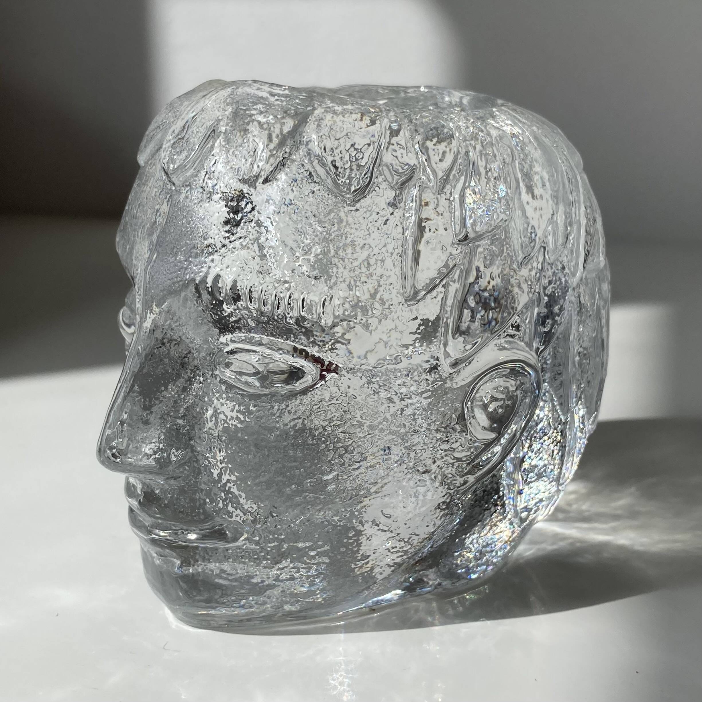 Glass candlestick by Bertil Vallien for Kosta Boda, man's head.