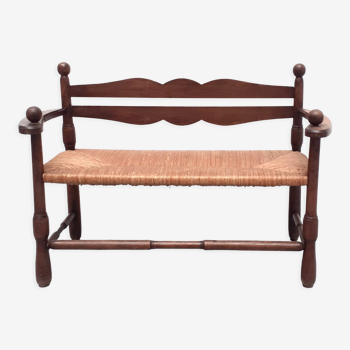 Vintage bench with wooden backrest and structure and mulched seat