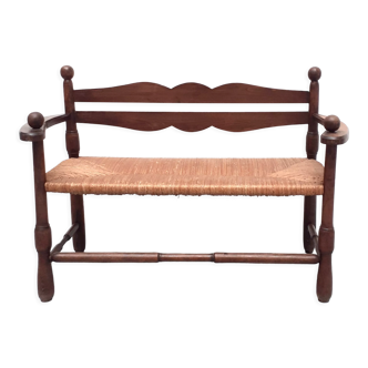 Vintage bench with wooden backrest and structure and mulched seat