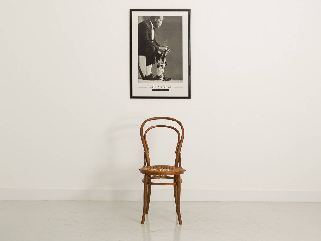 Bistro chair with curved wooden armrests and canning seat