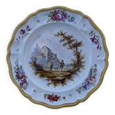 Glazed earthenware plate with hand-painted polychrome decoration.