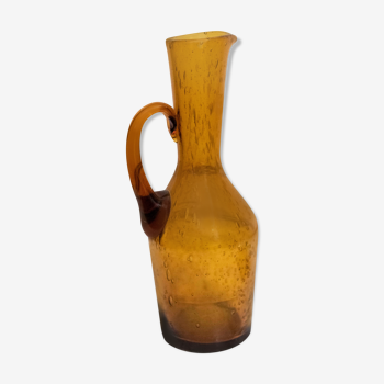 Old carafe in amber blown glass