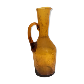 Old carafe in amber blown glass