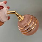 Vintage globe wall light in frosted pink and gold glass.