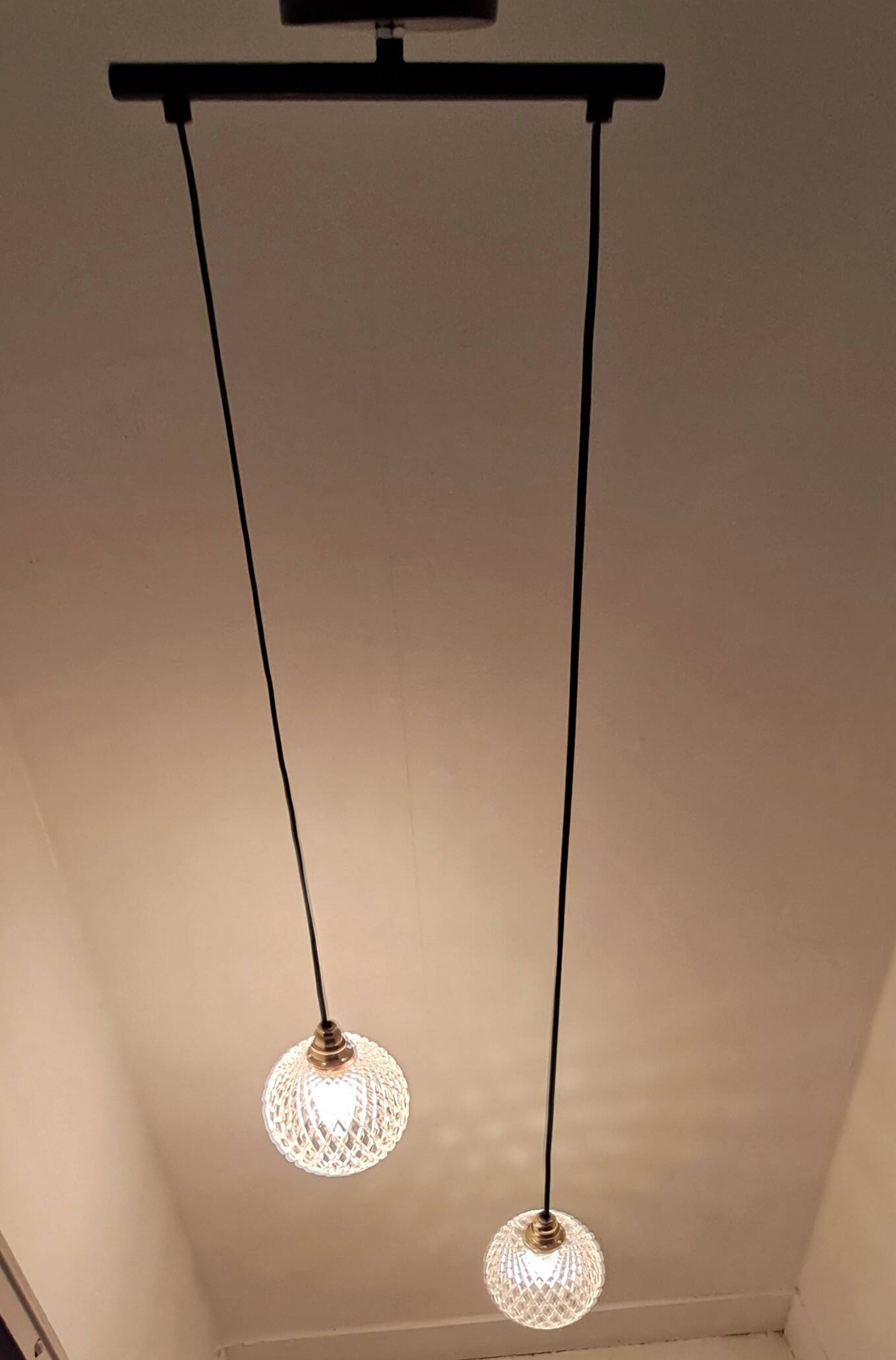 Two-light pendant in a cascade of cut crystal globe