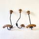 Trio of antique wooden and metal coat hooks