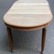 Large stripped solid oak dining table in Louis XVI style with 3 extensions.