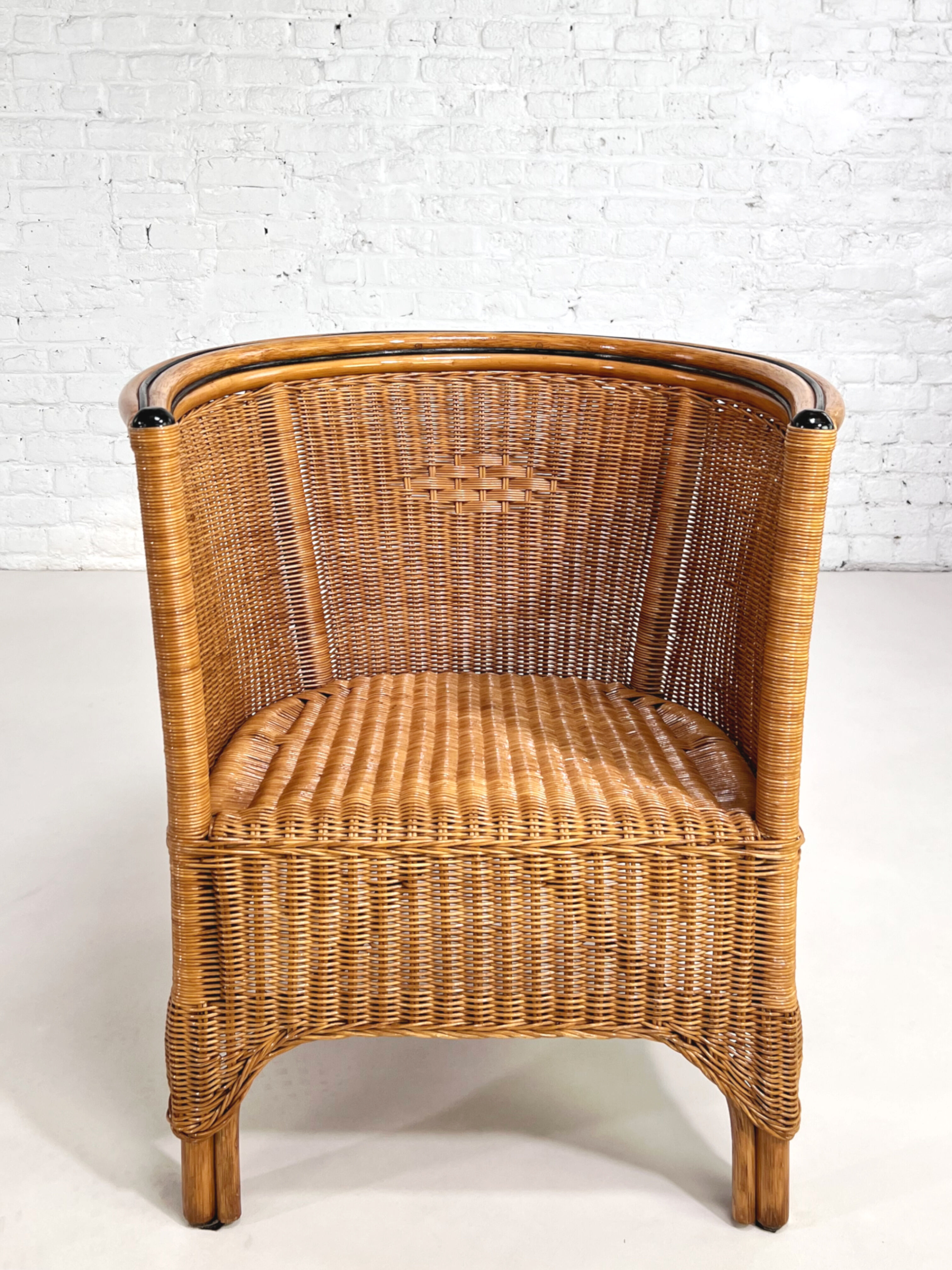 Pair of cabriolet armchairs in wicker and black edging