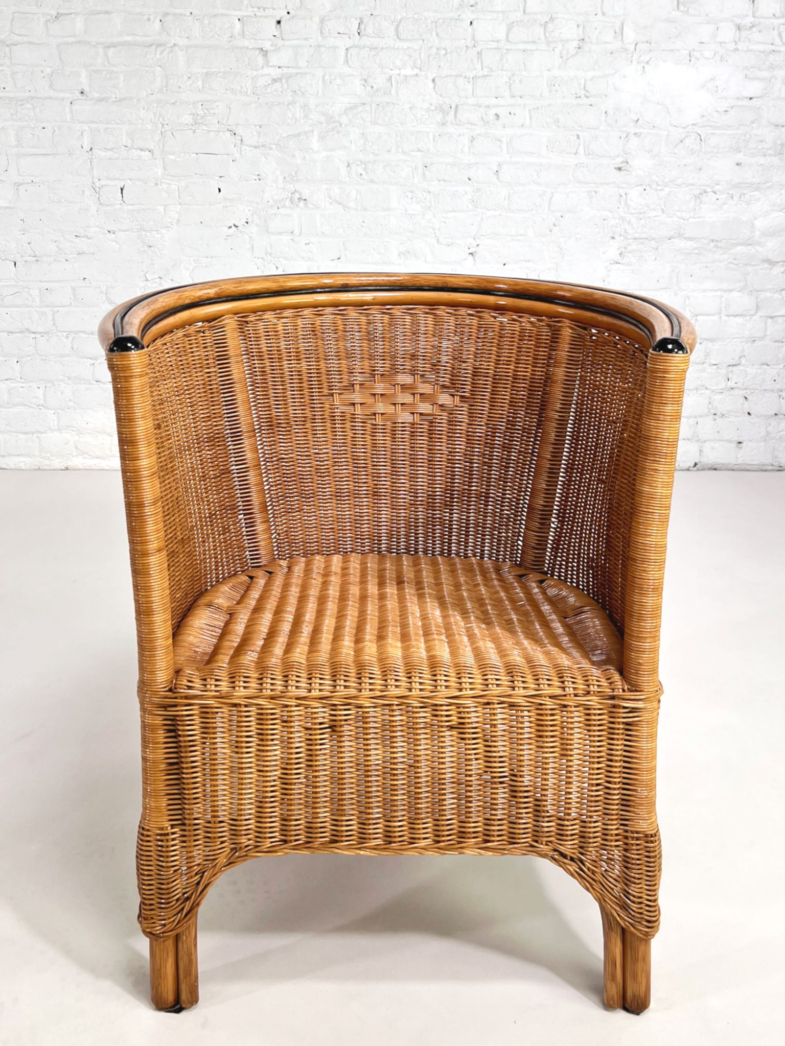 Pair of cabriolet armchairs in wicker and black edging