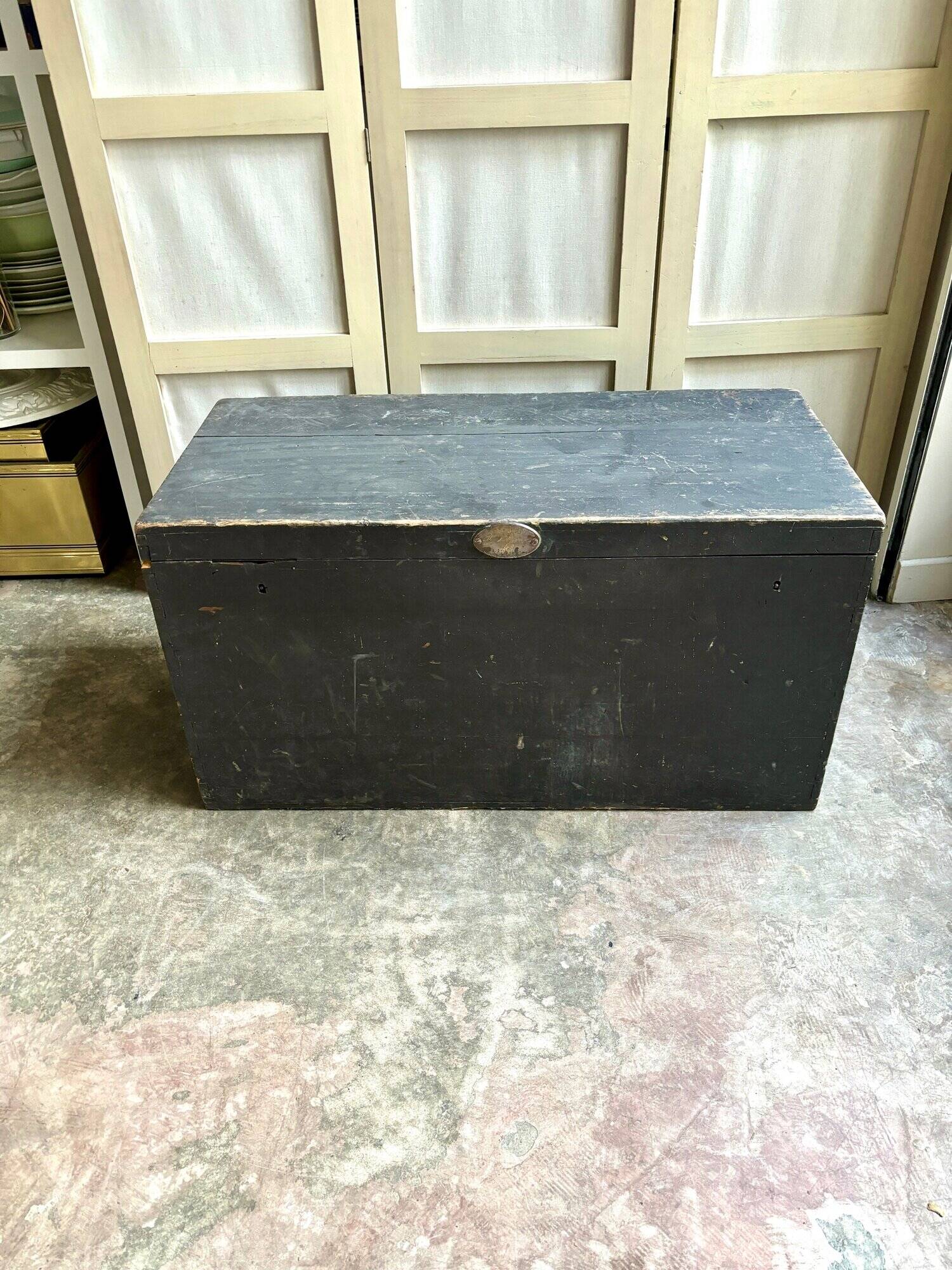 Trunk, black wooden chest and wallpaper
