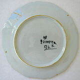 White-blue earthenware plate centered on a lily flower