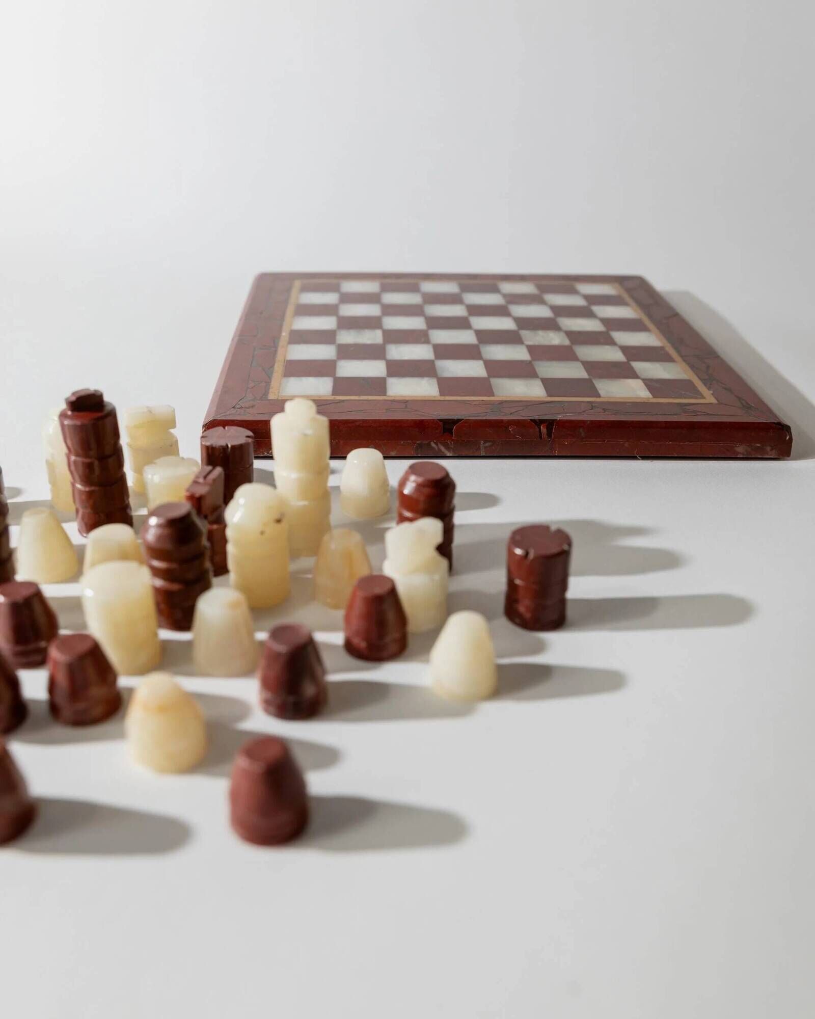 Vintage marble chess set from the 1960s, cream, burgundy and gold board with metal inlay, stone pieces.