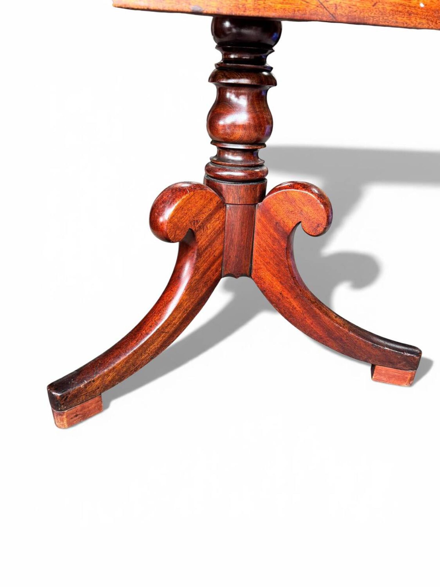 19th-century solid mahogany table with a tilting top and brass mechanism.