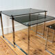 Nest of coffee tables in chrome with smoked glass top.