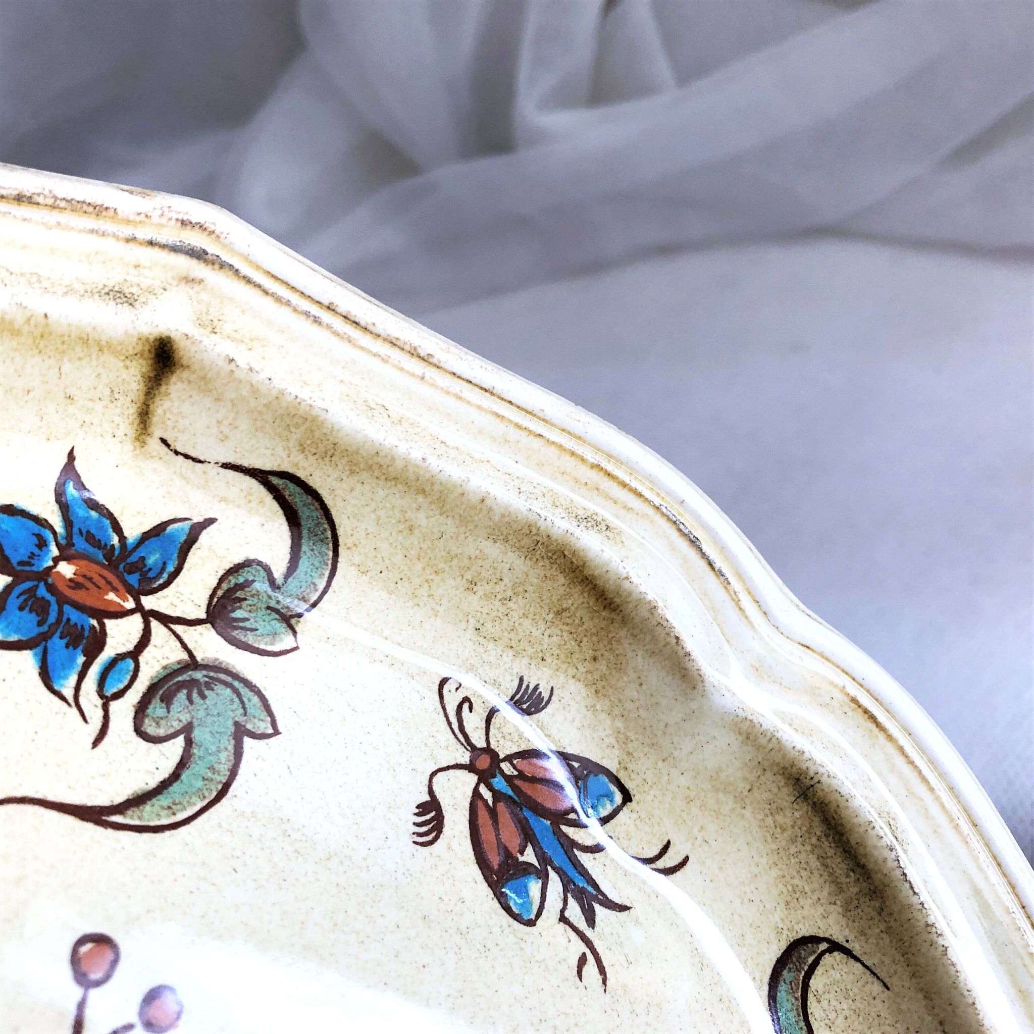 Decorative earthenware plate from Salins France, Moustiers decor, 25.5 cm