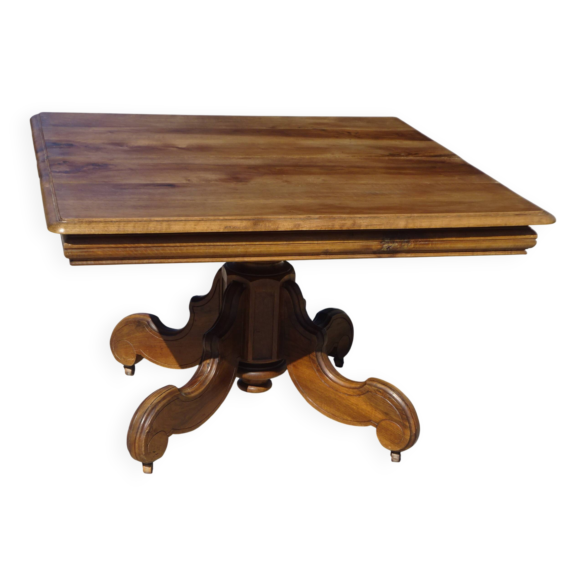 Old walnut table with a central leg.