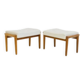 Pair of upholstered ottomans in teak and white leather.