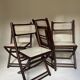 Set de quatre chaises pliantes en bois et cannage