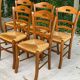 12 solid wood and straw chairs