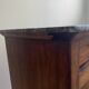 Vintage bedside table in the shape of a wooden column and a gray marble top